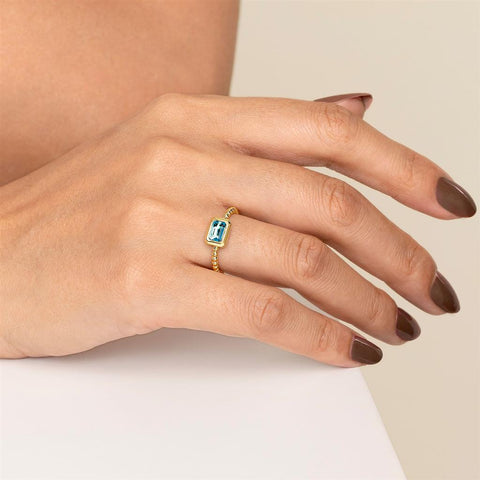 Gabriel & Co. 14k Yellow Gold Bujukan Bezel Set Blue Topaz and Beaded Shank Ring